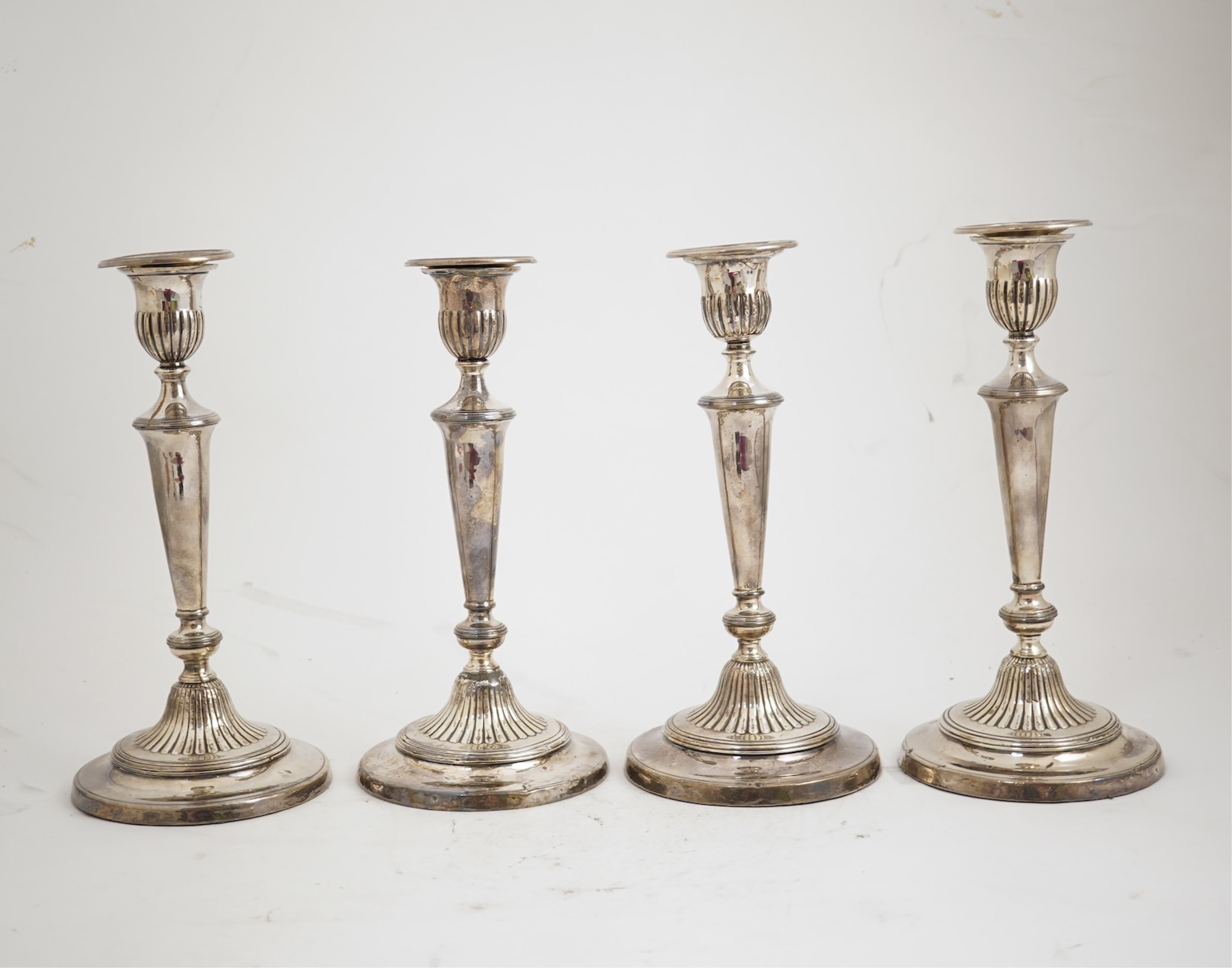 A set of four George III silver candlesticks by John Green, Roberts, Mosley & Co